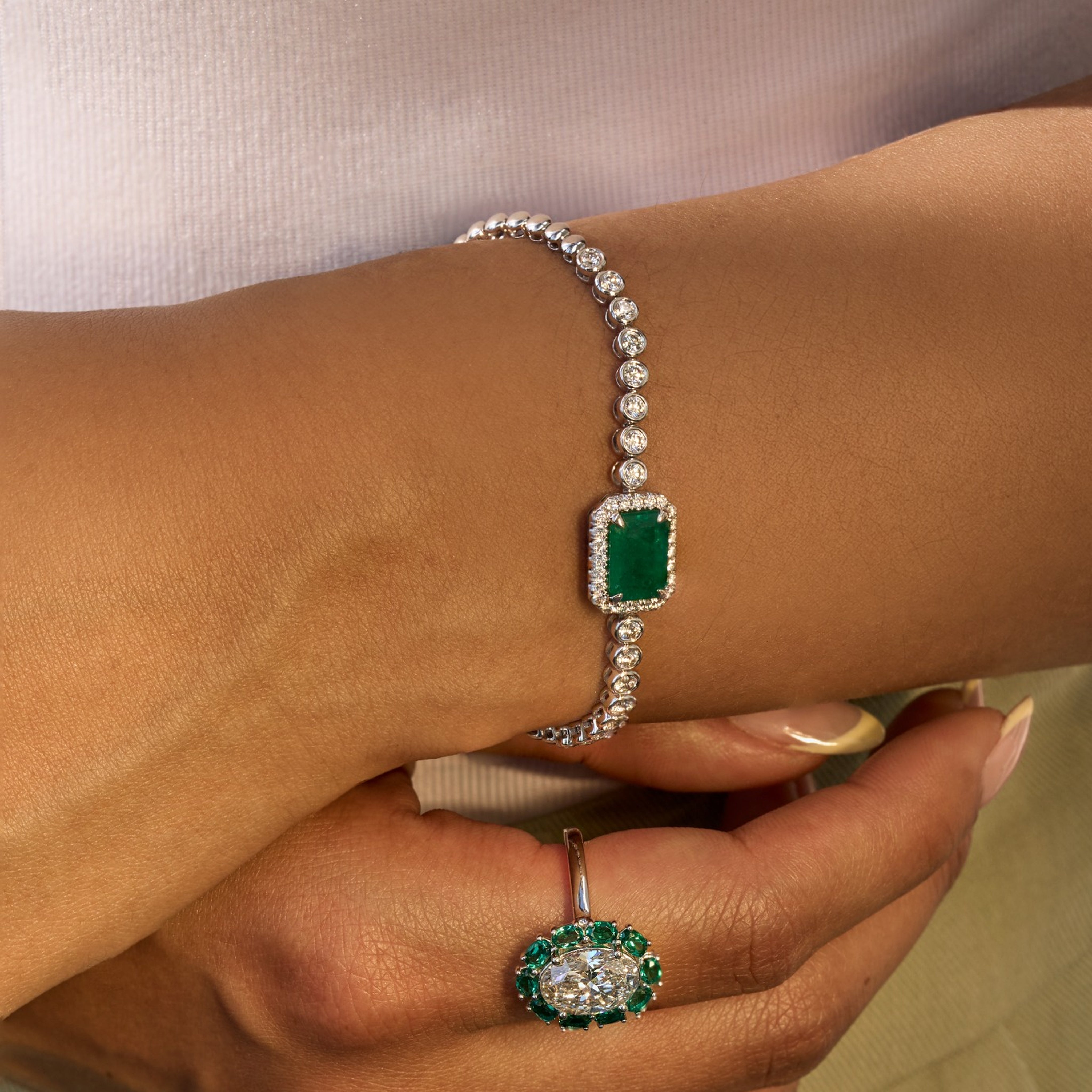 East West Emerald and Bezel Set Round Diamond Halo Bracelet - Happy Jewelers Fine Jewelry Lifetime Warranty