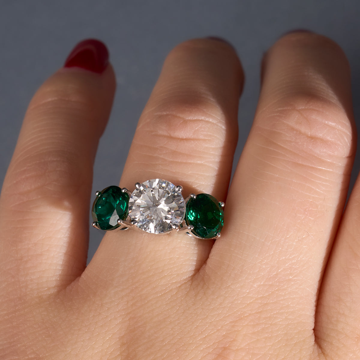 Round Diamond and Emerald Three Stone Engagement Ring