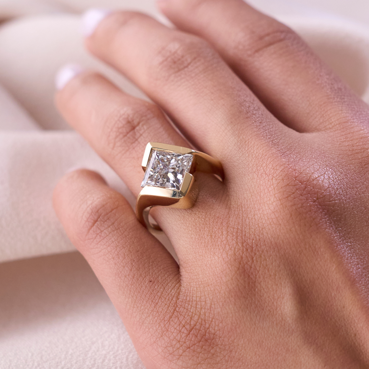 Princess half-bezel ring modeled on a hand